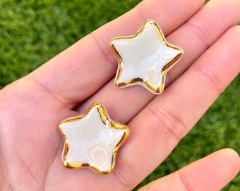 Porcelain little star’s earrings with 22K gold luster rim.