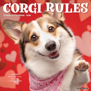 May include: A 2026 18-month calendar titled "CORGI RULES" featuring a smiling Corgi dog wearing a pink bandana with hearts. The background is red with white and pink hearts. The calendar includes a quote by Mahatma Gandhi.