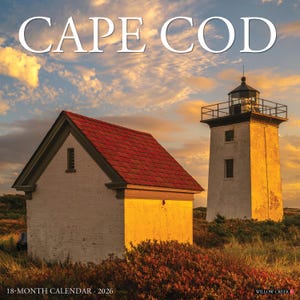 May include: A Cape Cod 18-month calendar for 2026. The image features a small white building with a red roof and a tall lighthouse under a sunset sky. The text "CAPE COD" is at the top of the calendar.