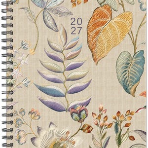 May include: A spiral-bound planner with a beige fabric-textured cover featuring a botanical print of various leaves and flowers in shades of orange, blue, purple, and green. The text 20 27 is printed in dark blue in the center of the cover.