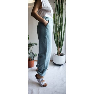 May include: A pair of light blue sweatpants with an elastic waistband. The sweatpants are made of a soft, comfortable fabric and have a relaxed fit.