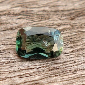 GSI Certified Teal Sapphire: 0.65 Carat Cushion Cut Gemstone