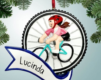 May include: A personalized Christmas ornament featuring a girl riding a bicycle with a blue banner that says "Lucinda".