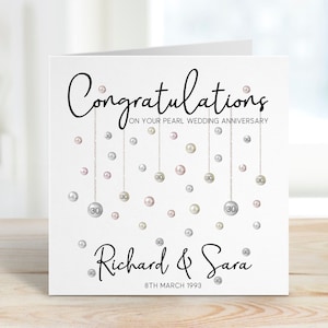 Congratulations on your pearl wedding anniversary. Beautiful hanging pearls and personalised with the couples name and date.