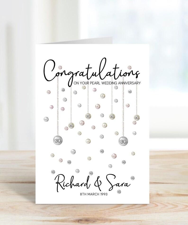 Congratulations on your pearl wedding anniversary. Beautiful hanging pearls and personalised with the couples name and date.