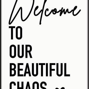 May include: Black and white typography print with the text "Welcome to our beautiful chaos" and a small heart symbol.