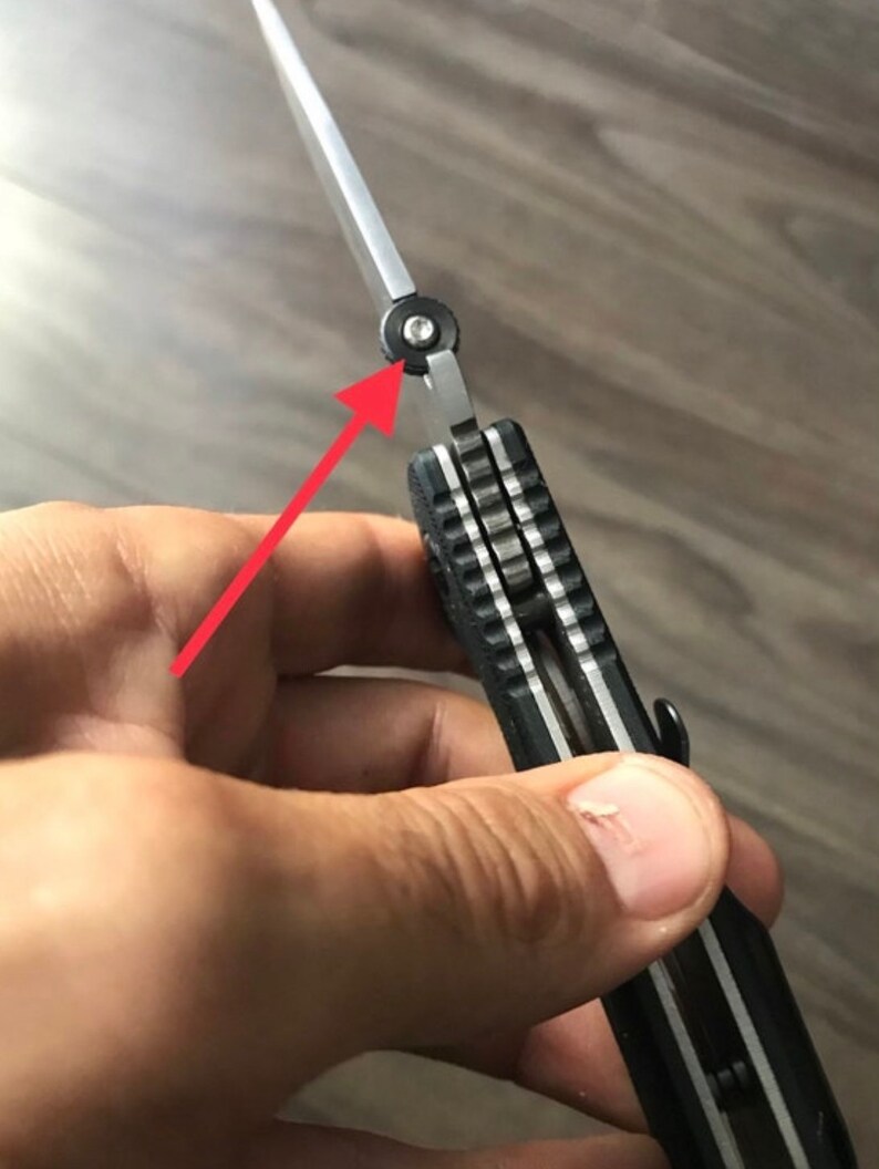 May include: A black and silver pocket knife with a partially open blade. The knife has a textured black handle and a silver blade with a black pivot screw.