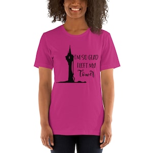 May include: A pink short-sleeved t-shirt with a black silhouette of a tower and the text "I'm so glad I left my tower".