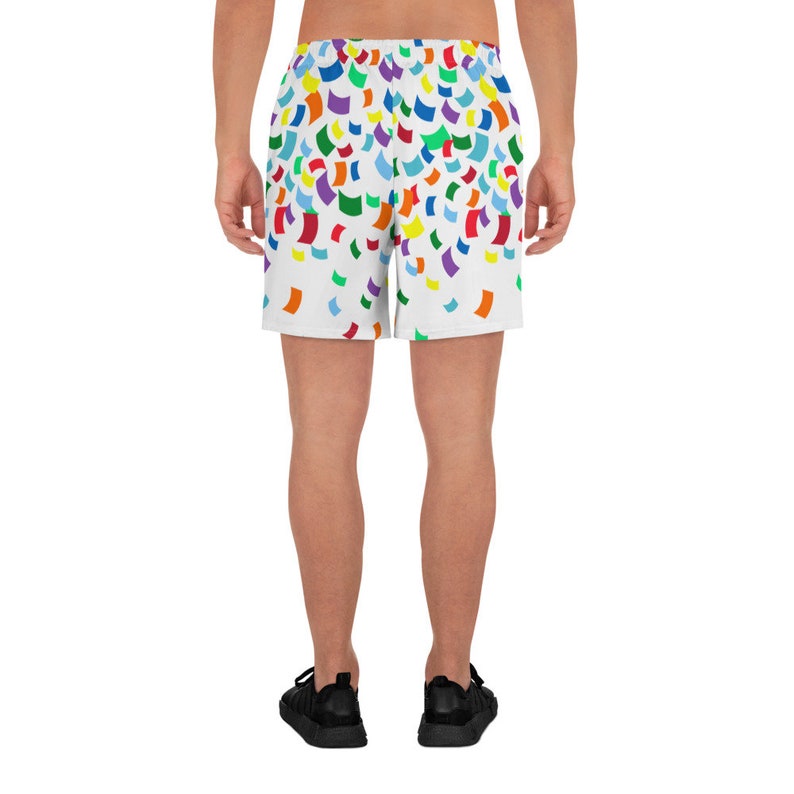 Pu&ograve; includere: Pantaloni corti sportivi bianchi con un motivo a coriandoli colorati. I pantaloncini hanno una cintura elastica e un cordoncino.