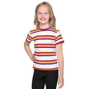 May include: A white short-sleeved t-shirt with colorful horizontal stripes in red, orange, yellow, purple, and blue. The shirt has a red ribbed crew neck.