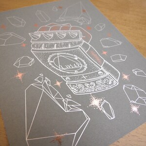 May include: A white line drawing of a metallic fist with a detailed design on a gray background. The fist is surrounded by white geometric shapes and small white stars. The background is a light gray color.