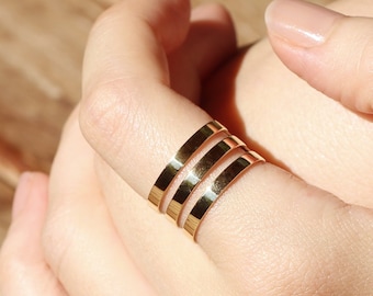 May include: A set of three gold-toned stacking rings. The rings are simple and elegant, and they would make a great gift for any occasion.