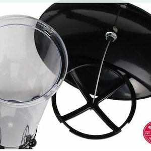 May include: A clear plastic bird feeder with a black metal base and a black dome-shaped lid. The feeder has a hanging wire and a red and white logo that says "Perky-Pet Est. 1958 No. 1 in Bird Feeders".