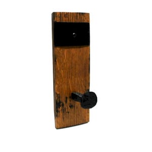 May include: A rustic wall hook made from a section of a wooden barrel. The hook features a dark brown finish with a black metal plate and a black nail head hook. The wood grain is visible.