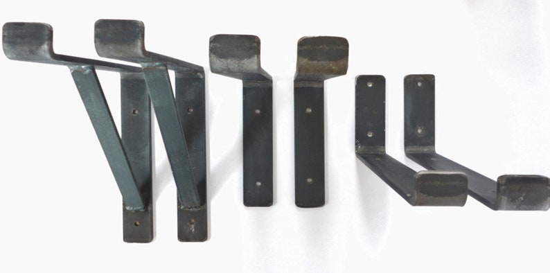 May include: Set of six black metal shelf brackets. Two brackets are angled and four are L-shaped.