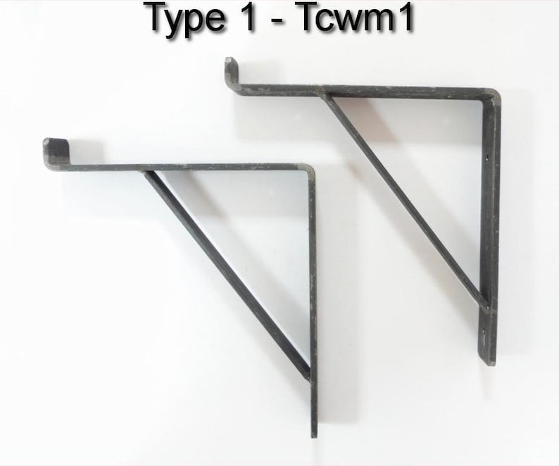 May include: Two black metal shelf brackets, each with a triangular support, are shown against a white background. The brackets are labeled "Type 1 - Tcwm1".