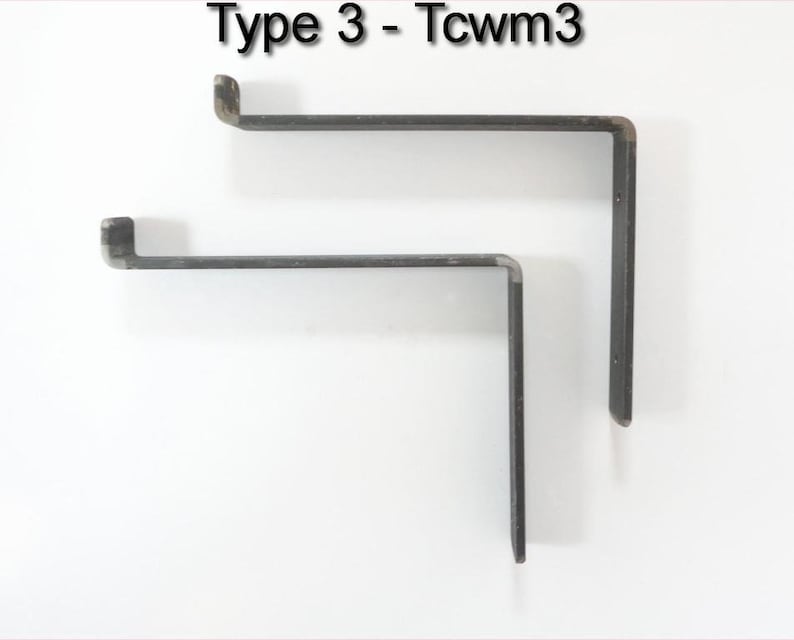 May include: Two black metal shelf brackets, one larger than the other, are shown against a white background. The brackets are L-shaped and have a slight curve at the top.