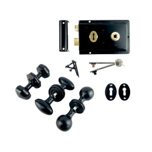 May include: Black door hardware set including two door knobs, two keyhole covers, a door lock, and two keys. The door knobs have a round shape with a long oval handle.