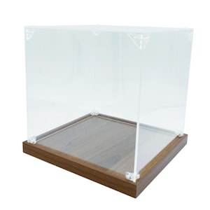 May include: A clear acrylic display case with a wooden base. The case is square shaped and made of clear acrylic. The base is made of wood and is brown in colour.