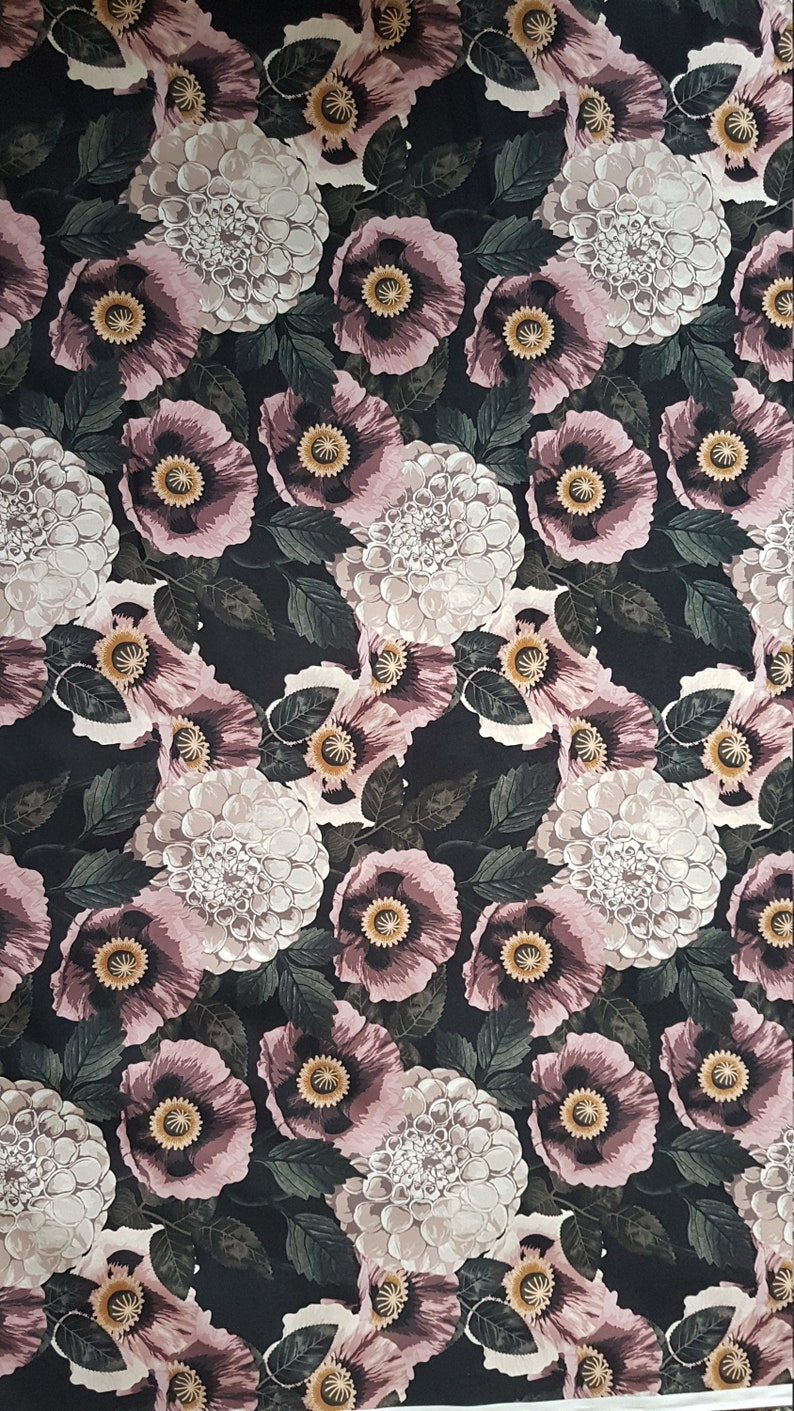 May include: A black fabric with a repeating pattern of pink and white flowers. The flowers are stylized and have a vintage feel.