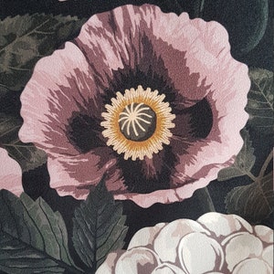 May include: A floral print fabric with large pink and white flowers on a black background. The flowers have a dark center with a yellow ring around it.