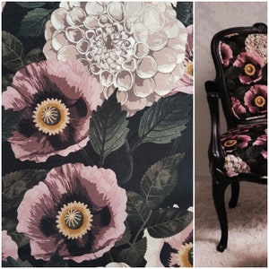 May include: A black chair with a floral upholstery featuring pink and white flowers on a black background. The chair has a high back and curved arms.