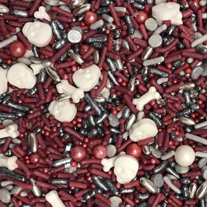 May include: A mix of red, white and silver sprinkles, including skull and bone shapes, ideal for decorating cakes and cupcakes.