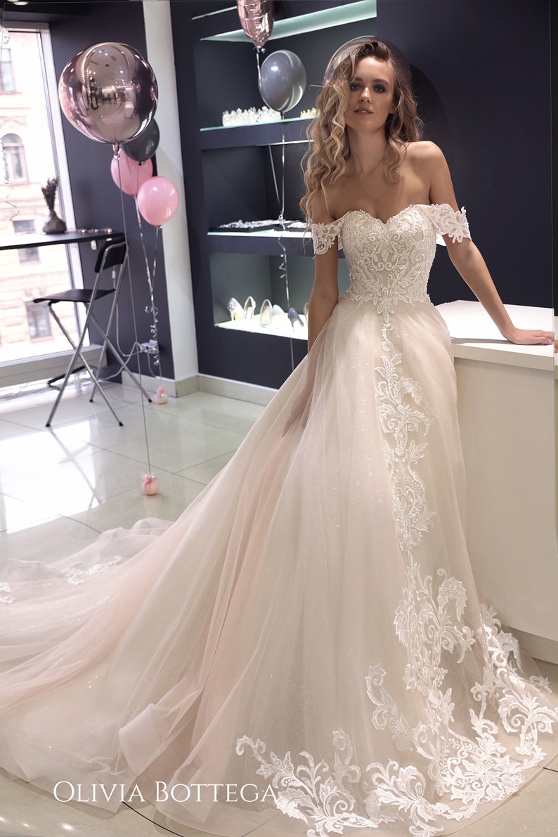 Off the shoulder wedding dress Ivia by Olivia Bottega. Open image 0