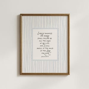 May include: Framed artwork featuring the text "Surely goodness and mercy shall follow me all the days of my life; and I will dwell in the house of the Lord forever. Psalm 23:6." The background has a light blue and white striped pattern.