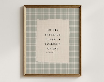 May include: Framed wall art with a gold-colored frame. The artwork features a light green plaid background with a torn-edge, off-white rectangle in the center. The text reads, "IN HIS PRESENCE THERE IS FULLNESS OF JOY, PSALM 16:11."