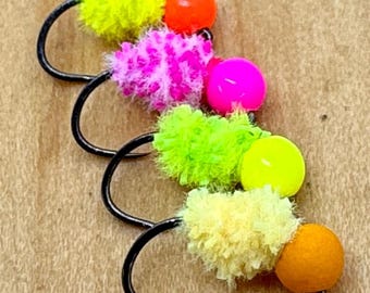 May include: Five colourful fly tying materials with beads. The materials are yellow, pink, green, and cream. The beads are orange, pink, yellow, and orange.