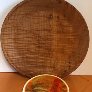A nine inch lathe turned plate made from curly maple.