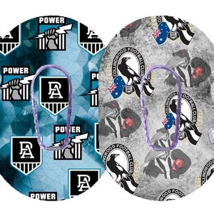 May include: Three round adhesive patches with different Australian Rules Football team logos. The logos are for the Richmond Tigers, Port Adelaide Power, and Collingwood Magpies. The patches are designed to be used with a continuous glucose monitor.