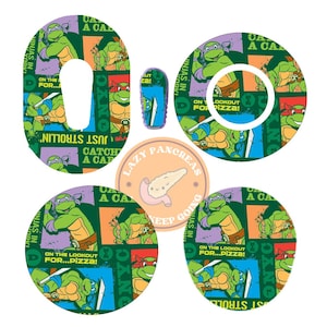May include: Four round, colourful, adhesive medical device covers featuring Teenage Mutant Ninja Turtles characters and the text "Catch a Carb" and "On the lookout for...pizza!"