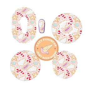 May include: A set of adhesive patches for medical devices featuring a light pink background with a repeating pattern of gingerbread cookies, candy canes, and the text MERRY. Includes a circular sticker with a cartoon pancreas and the text LAZY PANCREAS JUST KEEP GOING.