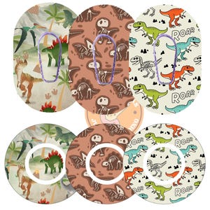 May include: A collection of six adhesive patches for medical devices, featuring three distinct dinosaur-themed patterns. The designs include a prehistoric landscape, a brown fossil print, and a cream background with green and orange dinosaurs and the text ROAR.
