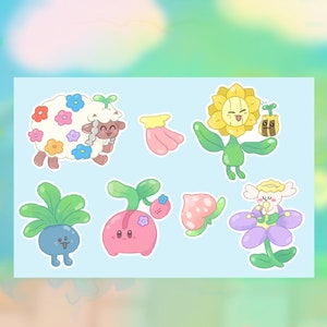 May include: A set of eight colorful cartoon stickers featuring various flower and plant characters. The stickers include a sheep with flowers, a sunflower, a pink flower, a blue flower, a pink plant, a green plant, and a white flower.