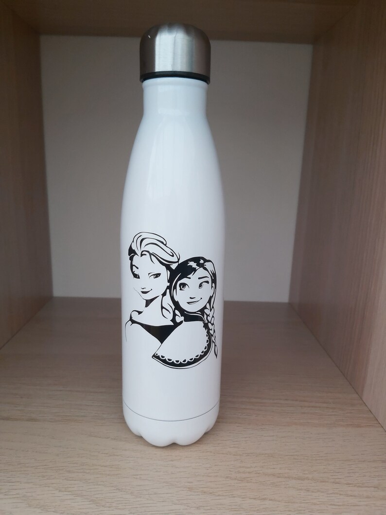 May include: White stainless steel water bottle with a black and white image of two girls with long hair. The girls are wearing dresses and have a crown on their heads.