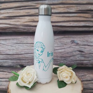 May include: White stainless steel water bottle with a teal outline of a cartoon princess and the name "Iris" printed on the side.