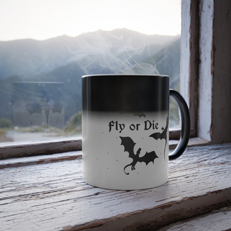 May include: A black and white color-changing mug with a dragon silhouette and the text "Fly or Die".