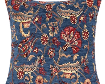 May include: Blue throw pillow with a floral pattern in shades of red, yellow, and brown. The pillow has a textured fabric and a square shape.