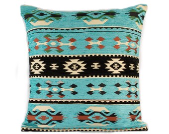 May include: A turquoise blue throw pillow with a geometric pattern in black, white, brown, and red. The pillow has a square shape and is made of a soft, textured fabric.