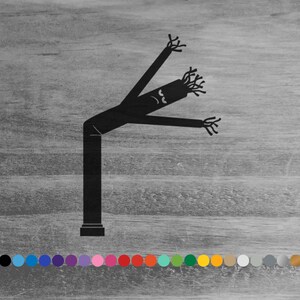 May include: Black silhouette of an inflatable tube man with arms raised and a silly face. The tube man is standing on a wood grain background.
