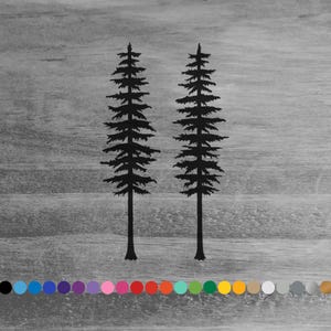 May include: Two black silhouette pine trees against a gray woodgrain background.
