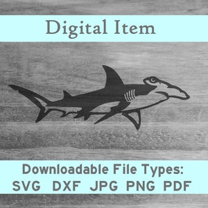 May include: A black silhouette of a hammerhead shark on a woodgrain background. The image is labeled "Digital Item" and "Downloadable File Types: SVG DXF JPG PNG PDF".
