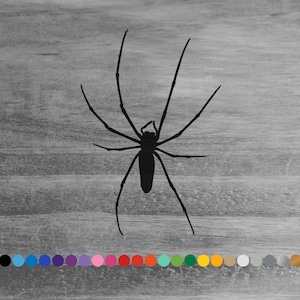 May include: Black silhouette of a spider with long legs on a woodgrain background. The spider is facing forward with its legs spread out.