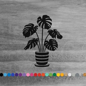 May include: Black silhouette of a potted plant with large, tropical leaves. The plant is in a simple, striped pot.