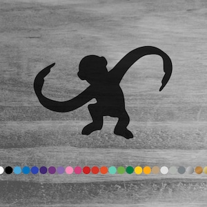 May include: A black silhouette of a stylized monkey in a playful pose, with arms outstretched and legs bent. The image is set against a gray, wood-grain background, with a row of colorful dots at the bottom.
