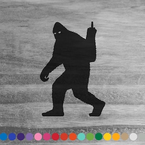 May include: Black silhouette of a Bigfoot giving the middle finger. The silhouette is on a woodgrain background.