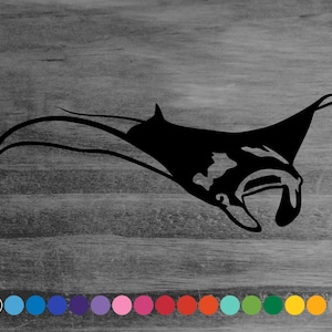 May include: Black silhouette of a manta ray, a large, flat fish with wing-like fins, against a wood grain background.